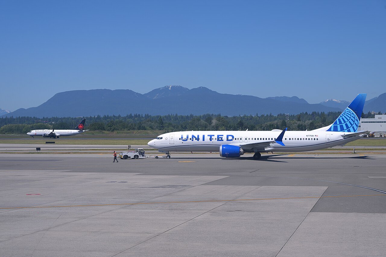 A Denver-bound United 737-9 MAX is pushed back while an Air Canada 737-8 MAX from Calgary lands at Vancouver International Airport
