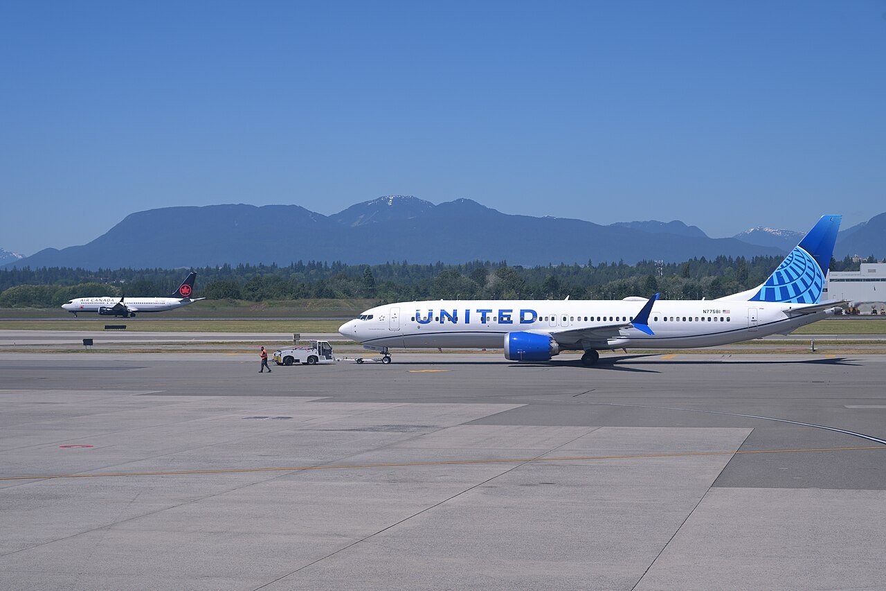 A Denver-bound United 737-9 MAX is pushed back while an Air Canada 737-8 MAX from Calgary lands at Vancouver International Airport
